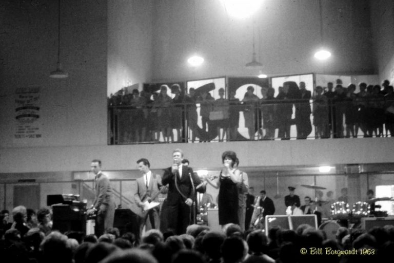 Black and White photo of band playing and the listening crowd.