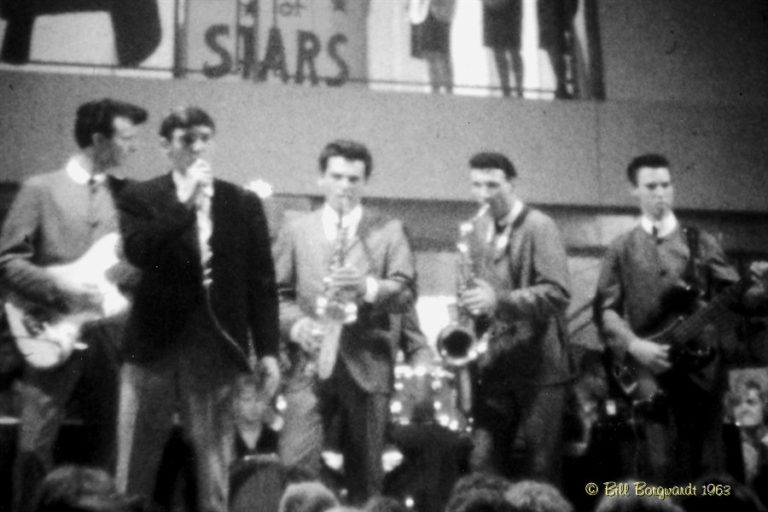 Black and White photo, 1963, 5 piece band featuring 2 saxophone players, a base player, guitar player and singer.