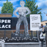 Detail from a mural in colour on 149th St and Stony Plain Road featuring "The Young Giant" sign and a policeman with two young boys.