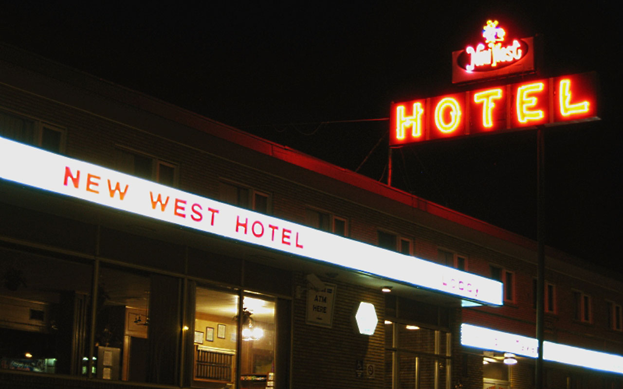 Colour photo of exterior with neon sign at New West Hotel, January 1, 1980. Courtesy of Paul Balanchuk via Flickr.