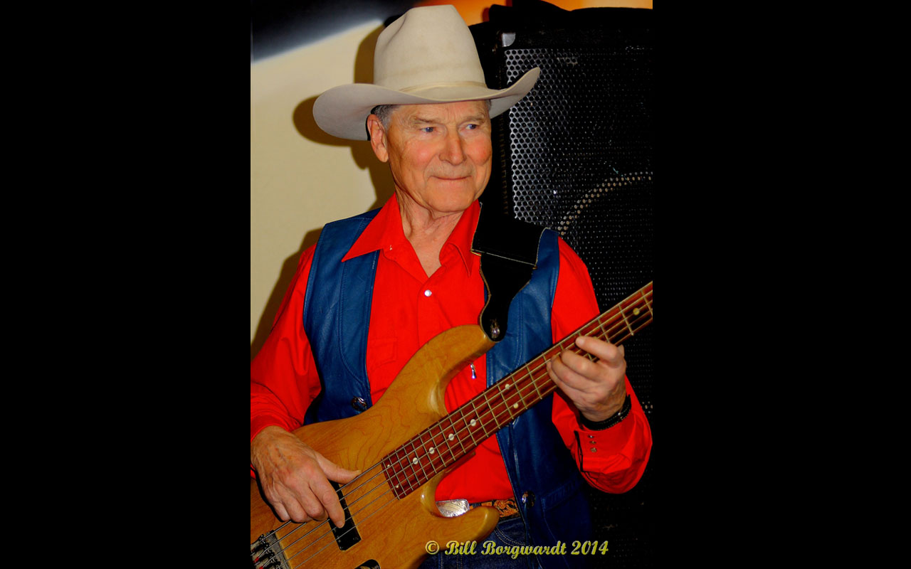 Colour photo of George Myren with guitar at the New West Hotel, 2014. Courtesy of Bill Borgwardt.