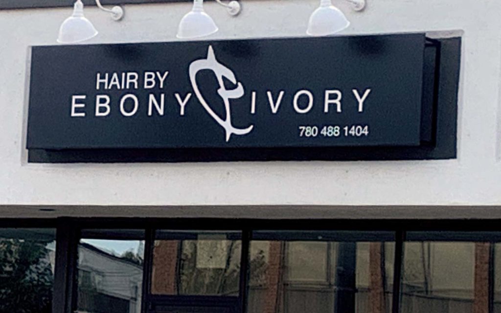 Colour sign of Shirley Romany's former place of business, Hair by Ebony & Ivory.